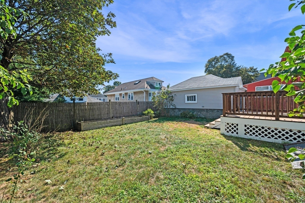 21 Lyman Street Beverly, MA 01915 - Photo 27 of 33 a view of a house with a wooden fence