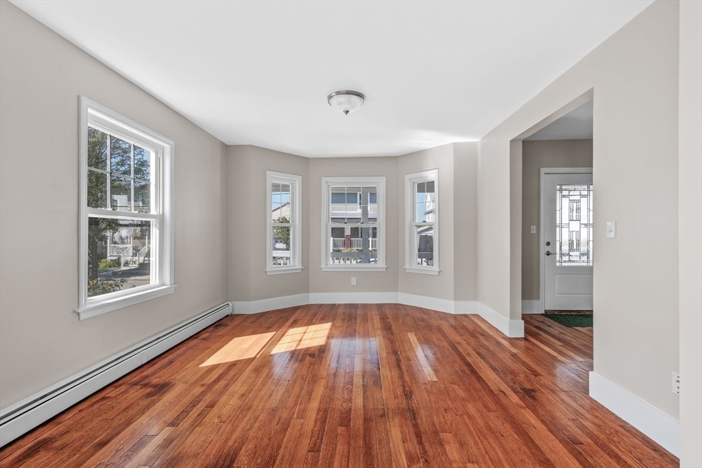 21 Lyman Street Beverly, MA 01915 - Photo 7 of 33 wooden floor in an empty room with a window