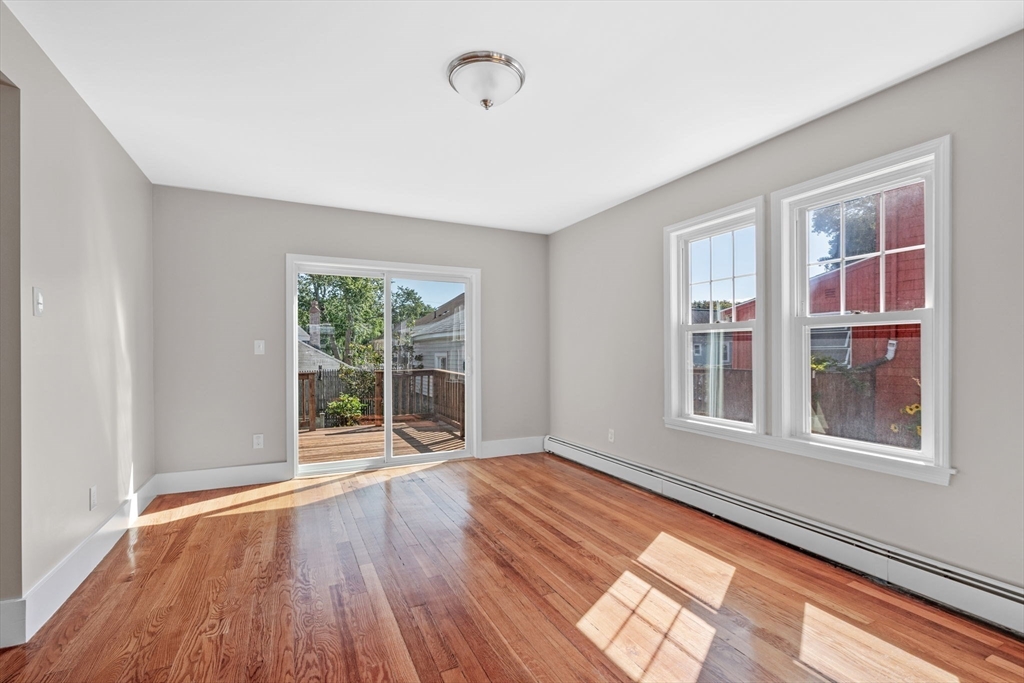 21 Lyman Street Beverly, MA 01915 - Photo 8 of 33 a view of an empty room with wooden floor and a window