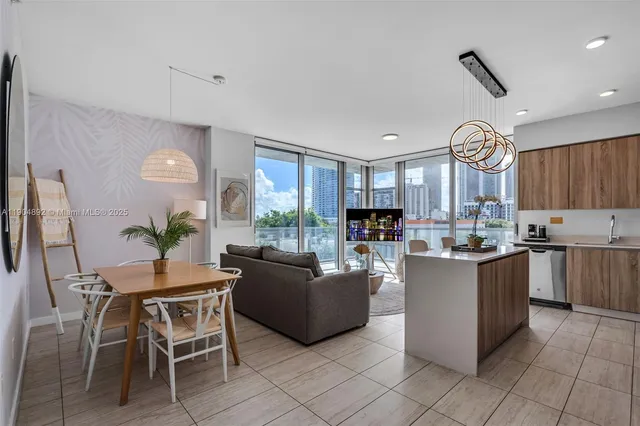 a living room with kitchen island furniture and a large window