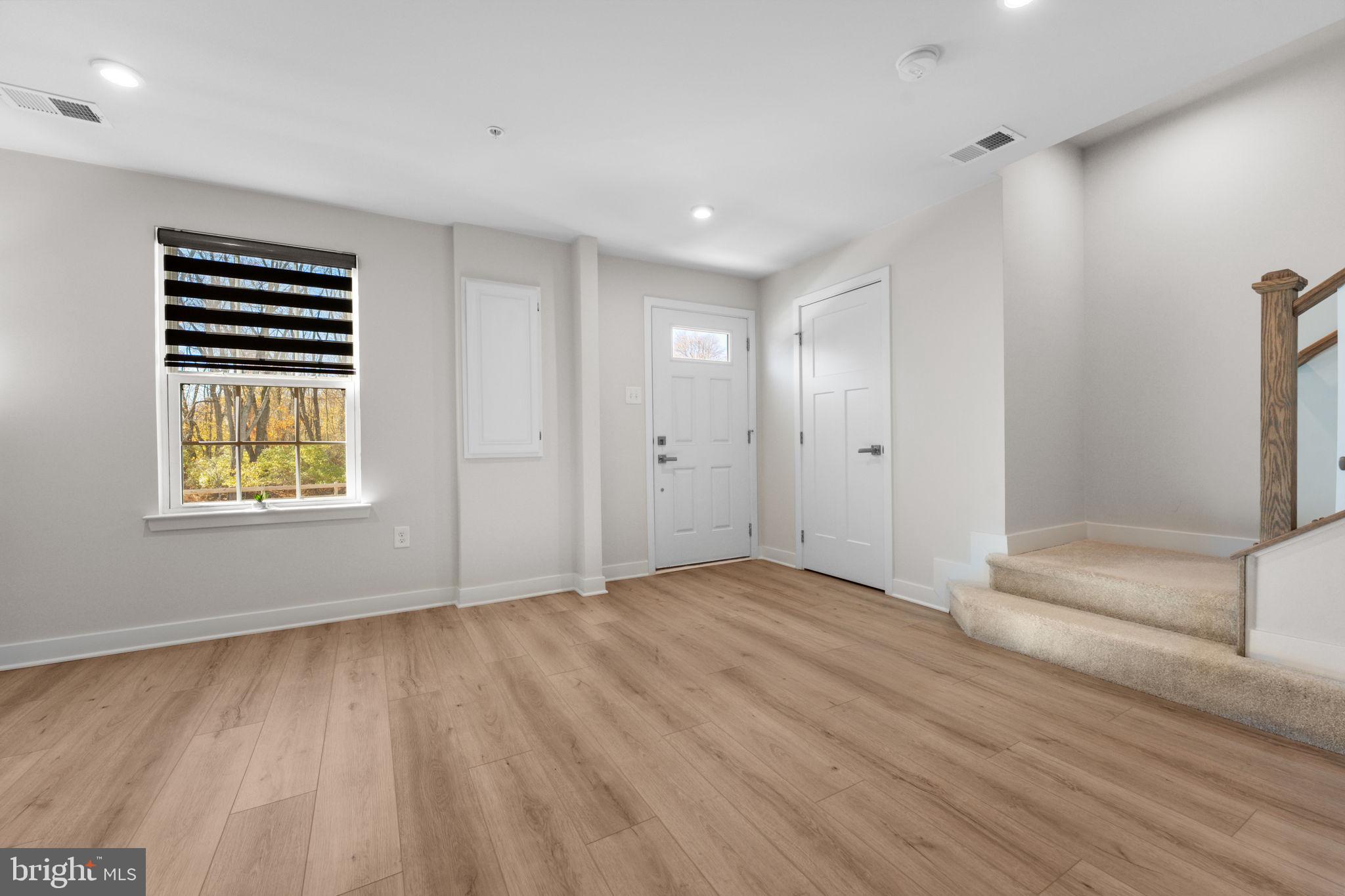 316 Longs Peak Way Exton, PA 19341 - Photo 38 of 46 a view of an empty room with a window and wooden floor