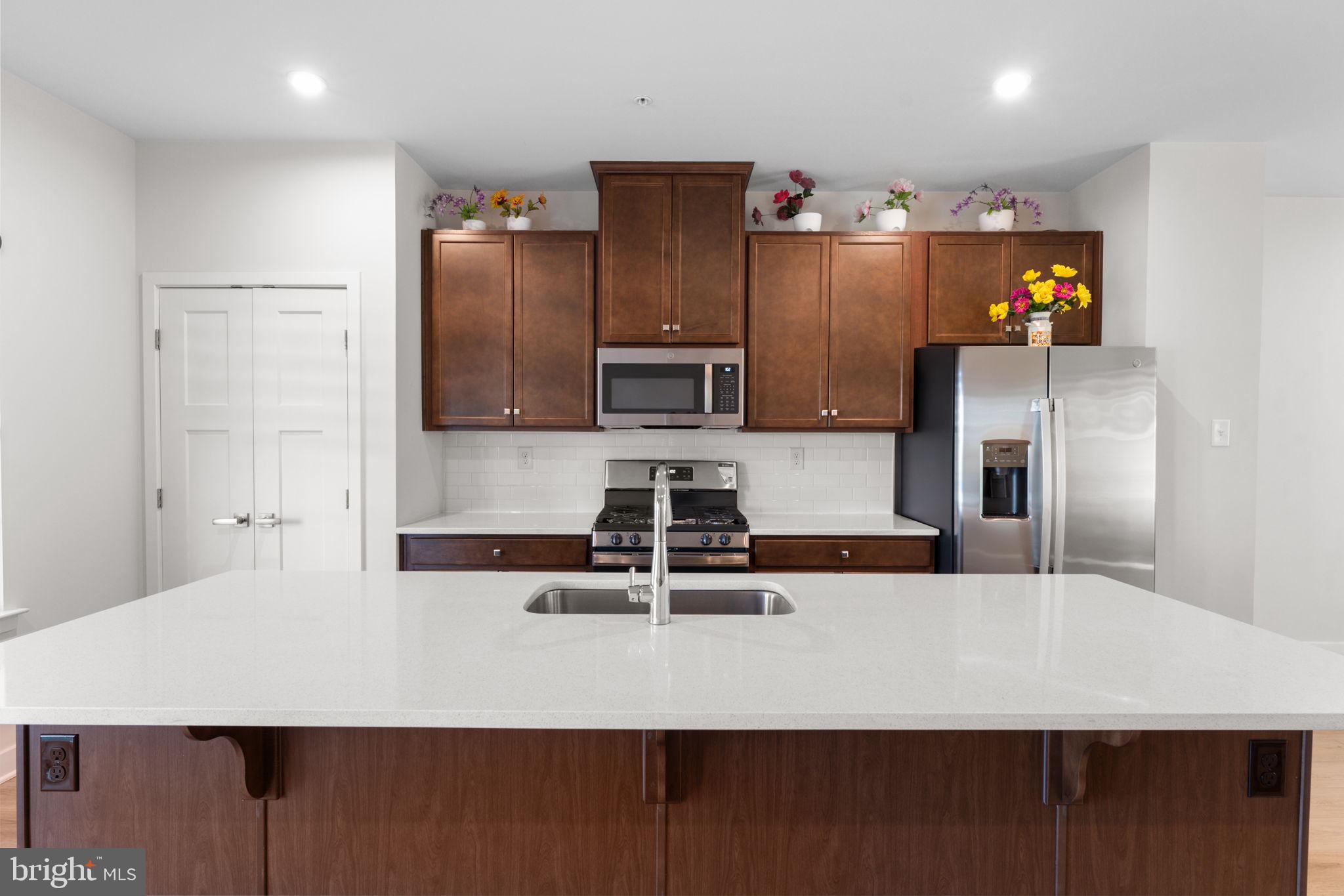 316 Longs Peak Way Exton, PA 19341 - Photo 7 of 46 a kitchen with kitchen island a counter top space cabinets and stainless steel appliances