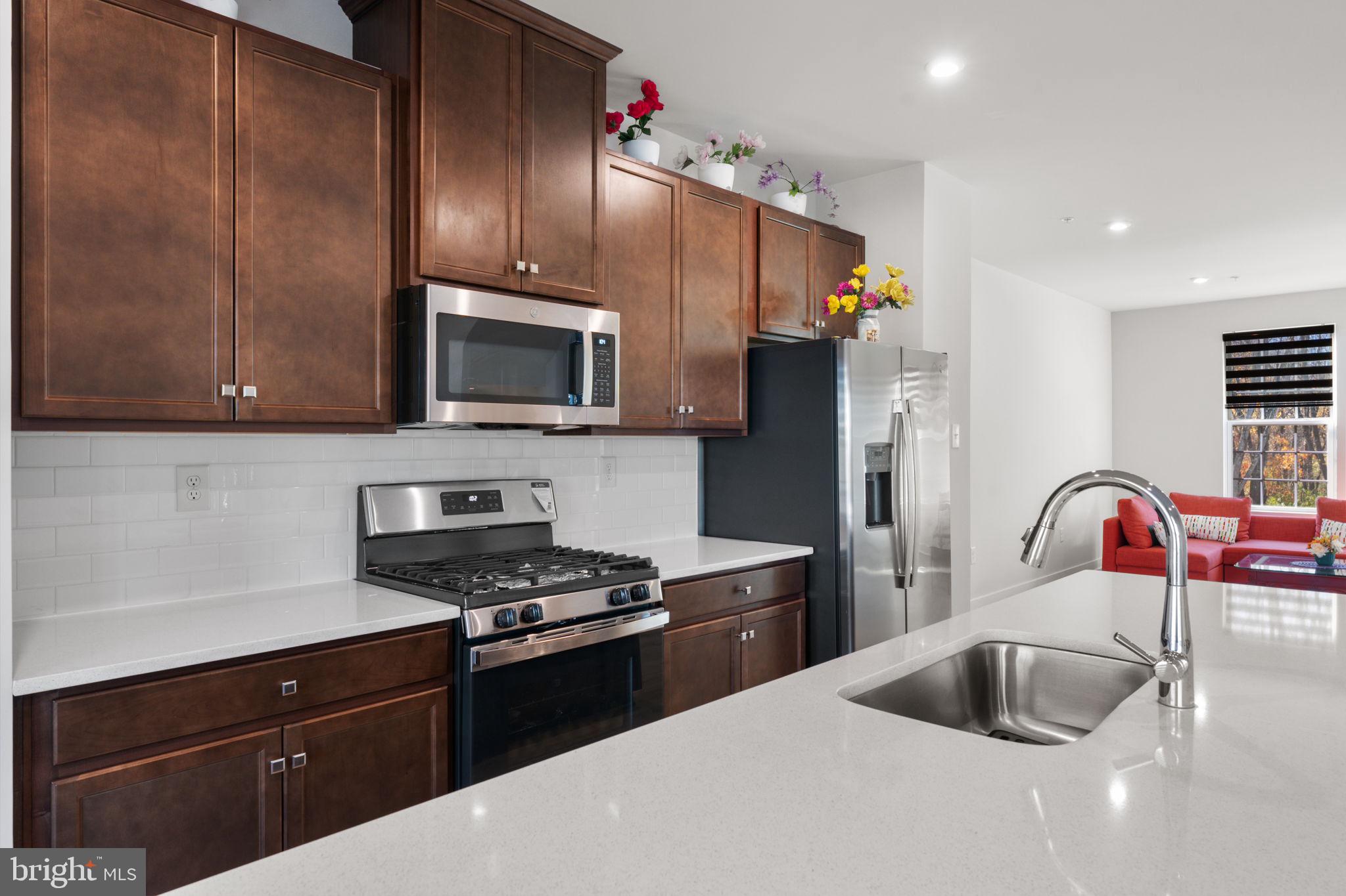 316 Longs Peak Way Exton, PA 19341 - Photo 8 of 46 a kitchen with refrigerator a microwave a sink and cabinets
