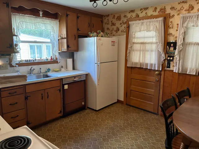 a kitchen with a refrigerator and a sink