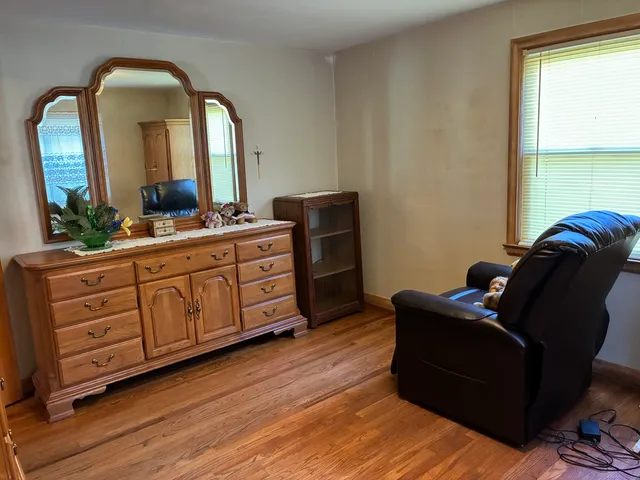 a living room with furniture and a mirror