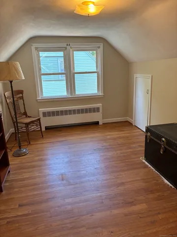 a view of a room with wooden floor and stairs