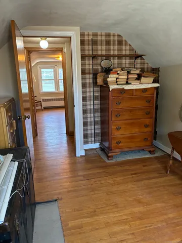 a view of a room with wooden floor