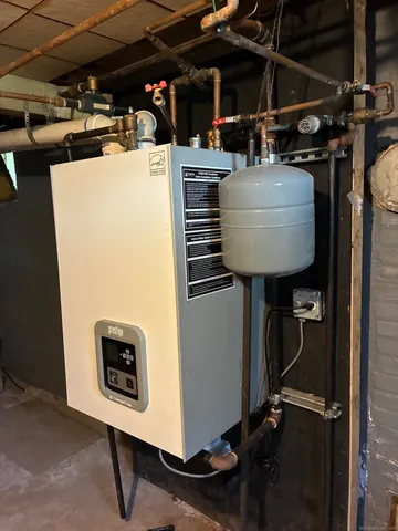 a room with water heater and a table