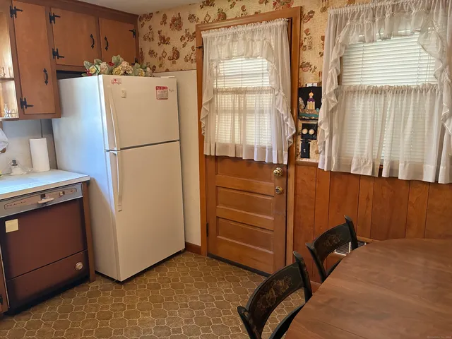 a room with cabinets and a refrigerator