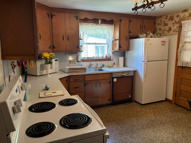 a kitchen with a refrigerator a stove and a sink