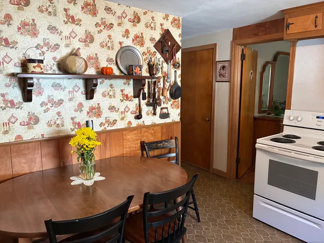 a dining room with furniture and wooden floor