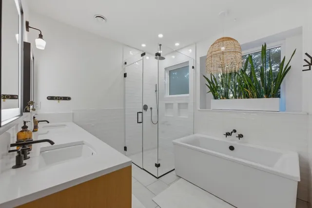 a bathroom with a tub sink and mirror
