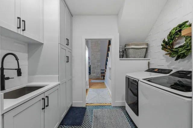 a kitchen with a sink and a stove top oven
