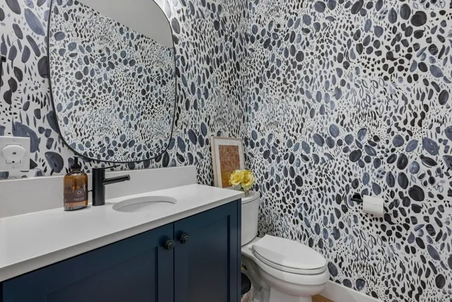 a bathroom with a sink a toilet and a mirror