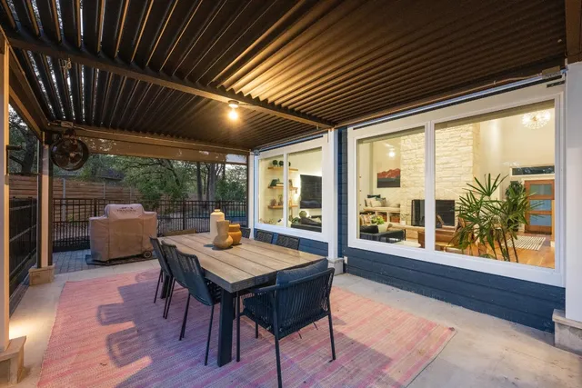 a living room with furniture floor to ceiling window and wooden floor