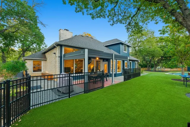 a view of a house with a yard and deck
