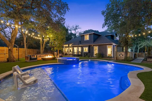a view of a house with swimming pool and sitting area