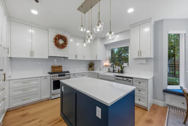 a kitchen with a stove and a white cabinets