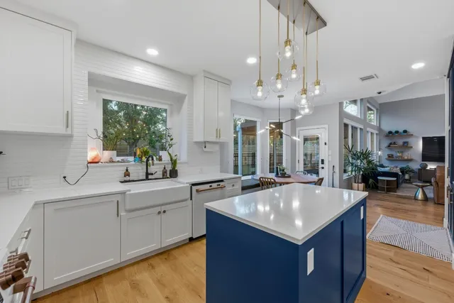 a kitchen with stainless steel appliances granite countertop a sink and a stove