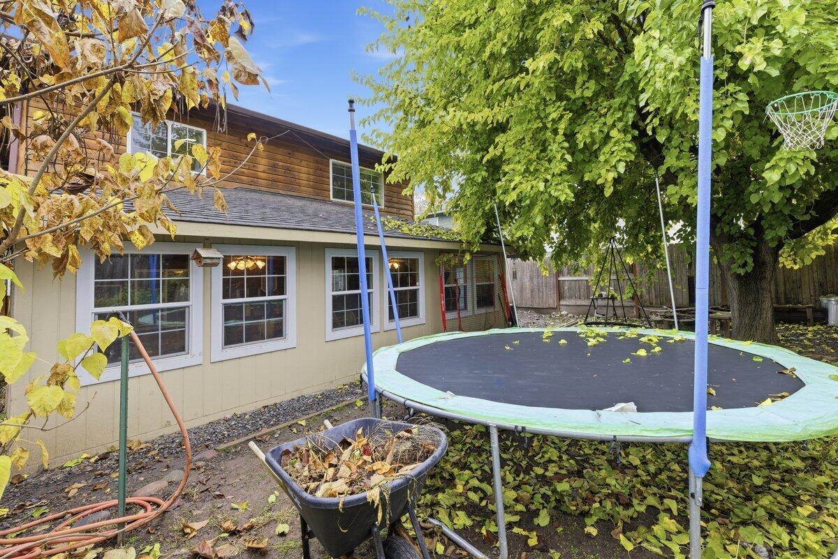 650 Sarah Lane Eagle Point, OR 97524 - Photo 19 of 19 a view of a house with backyard sitting area and garden
