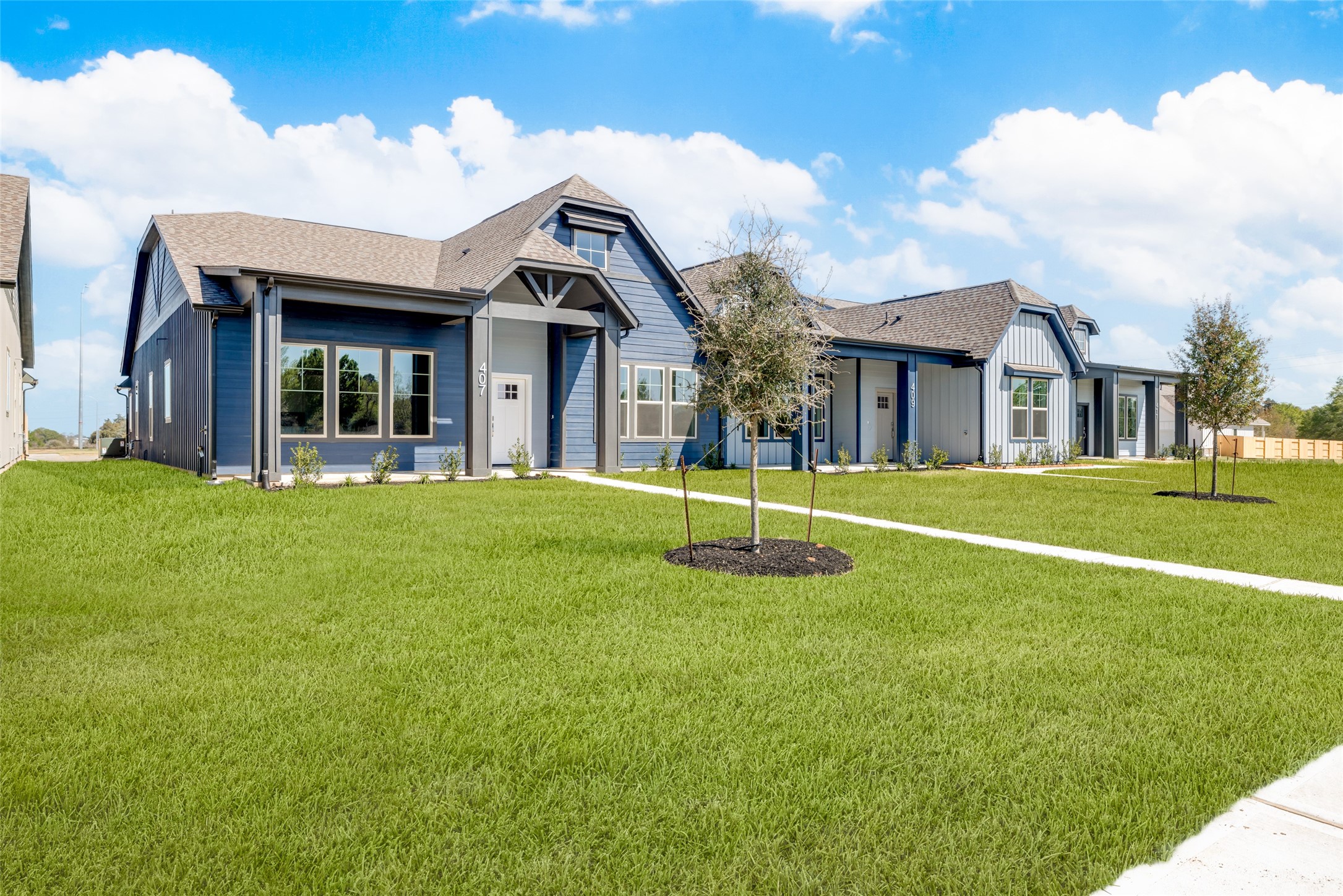 407 Legacy Point, Unit A Sealy, TX 77474 - Photo 3 of 28 a view of a house with a yard