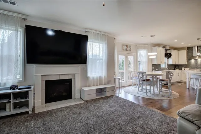 a living room with furniture a flat screen tv and a fireplace