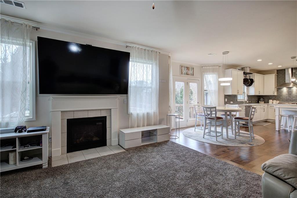 218 Orchard Trail Canton, GA 30115 - Photo 14 of 39 a living room with furniture a flat screen tv and a fireplace