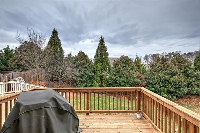 a view of a balcony with wooden fence and floor