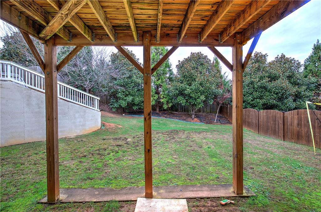 218 Orchard Trail Canton, GA 30115 - Photo 17 of 39 a view of a backyard with large trees and wooden fence