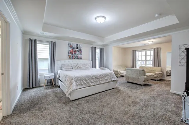 a spacious bedroom with a bed and a couch