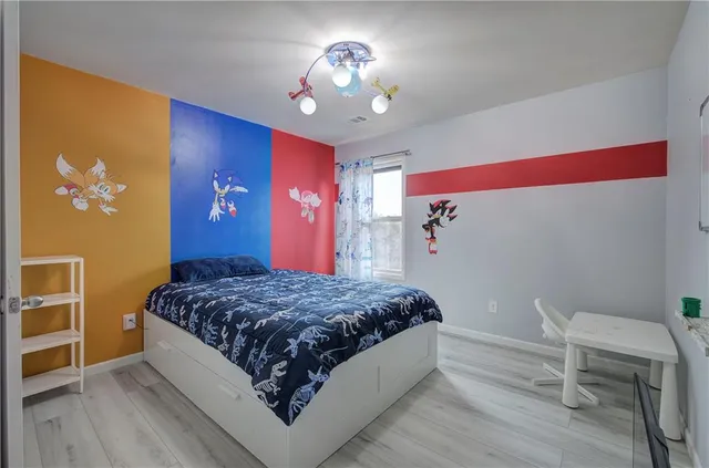 a bedroom with a bed and a chandelier