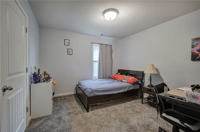 a bed room with a bed and a window