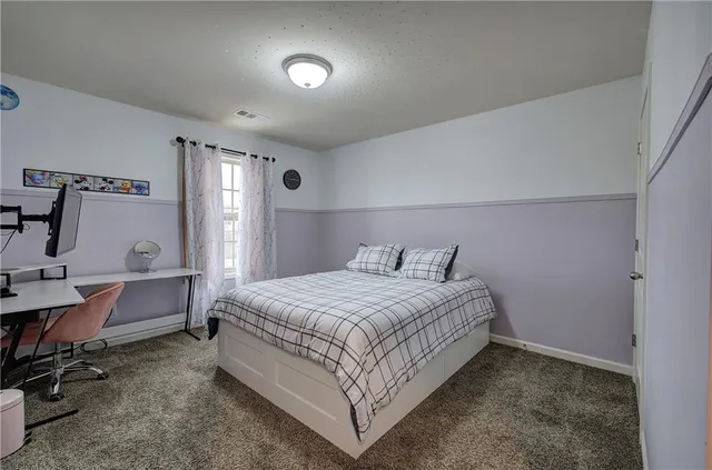 a bedroom with a bed and a desk