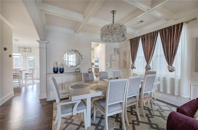 a view of a dining room with furniture wooden floor and chandelier