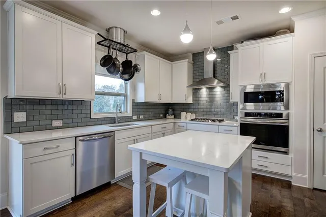 a kitchen with a sink a microwave and cabinets