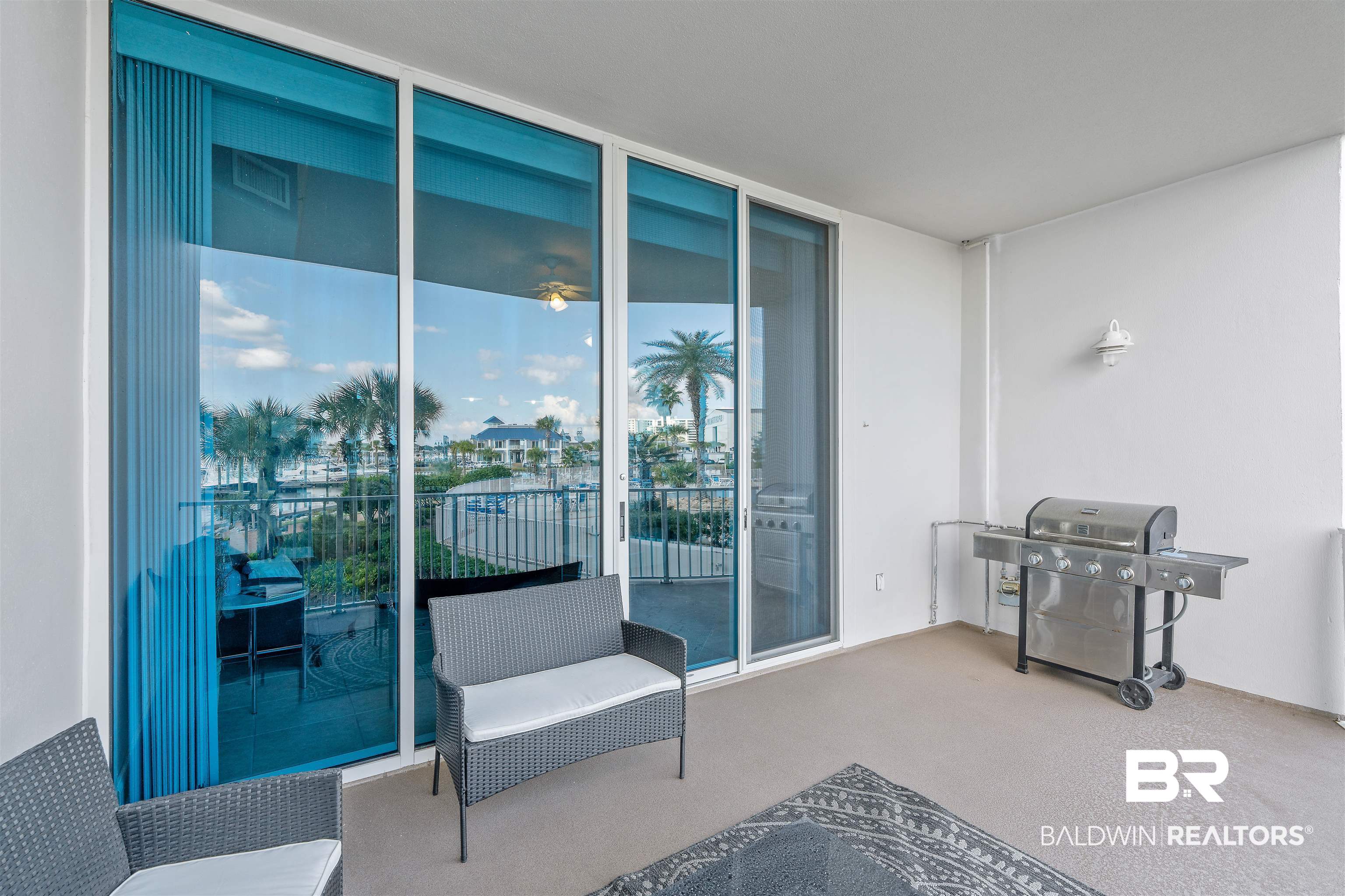 27800 Canal Road, Unit 113 Orange Beach, AL 36561 - Photo 20 of 35 Living area featuring expansive windows and carpet floors
