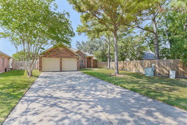 a front view of a house with a yard and trees