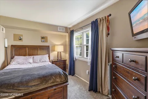 a bedroom with a bed and a tv