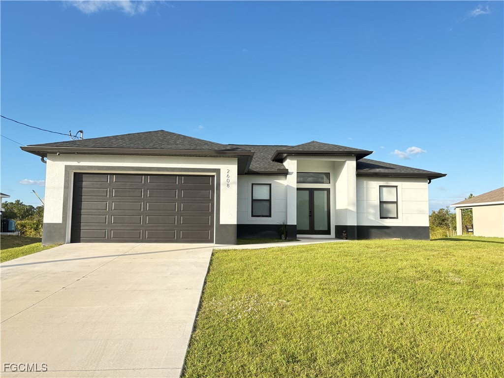 a front view of a house with a garden and yard