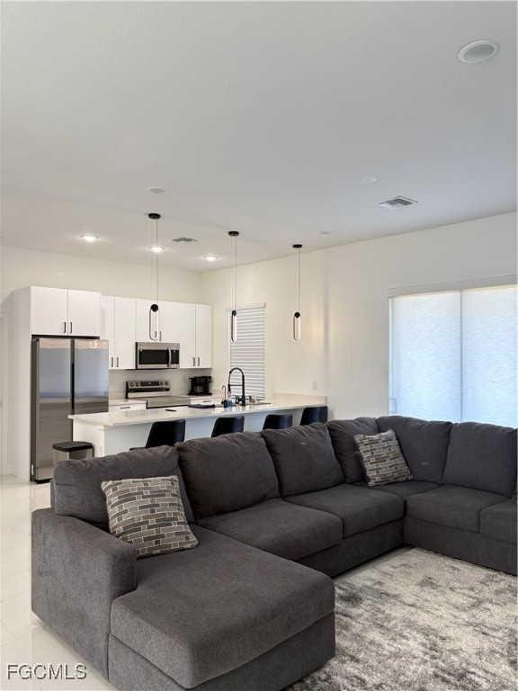 2608 25th Street West Lehigh Acres, FL 33971 - Photo 15 of 27 a living room with a couches and kitchen view