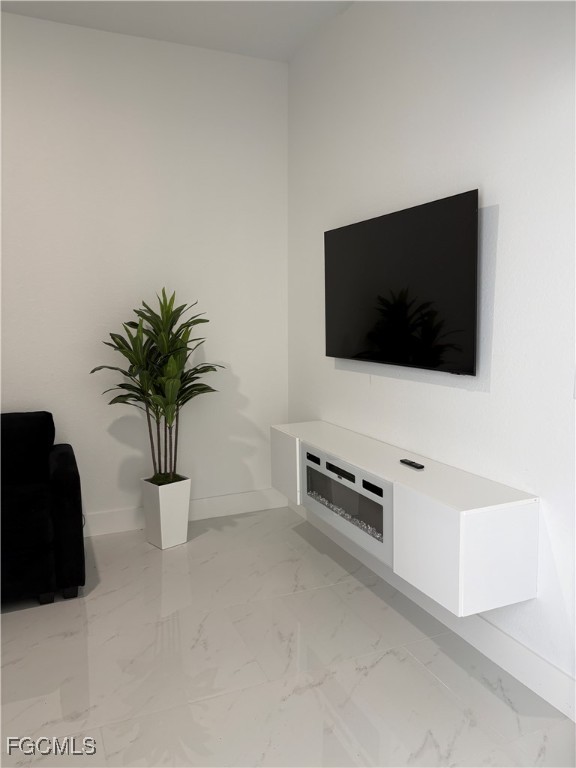 2608 25th Street West Lehigh Acres, FL 33971 - Photo 16 of 27 a living room with furniture and a flat screen tv