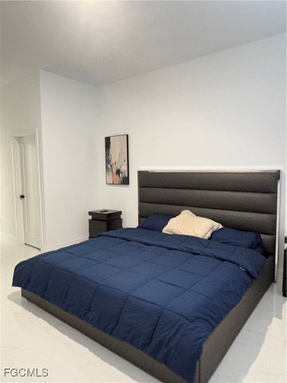 2608 25th Street West Lehigh Acres, FL 33971 - Photo 18 of 27 a bedroom with a bed and furniture