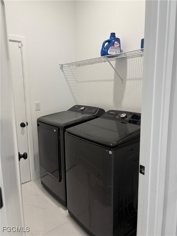 2608 25th Street West Lehigh Acres, FL 33971 - Photo 25 of 27 a utility room with dryer and washer
