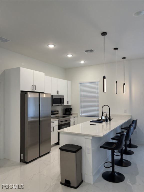 2608 25th Street West Lehigh Acres, FL 33971 - Photo 26 of 27 a kitchen with refrigerator and chairs