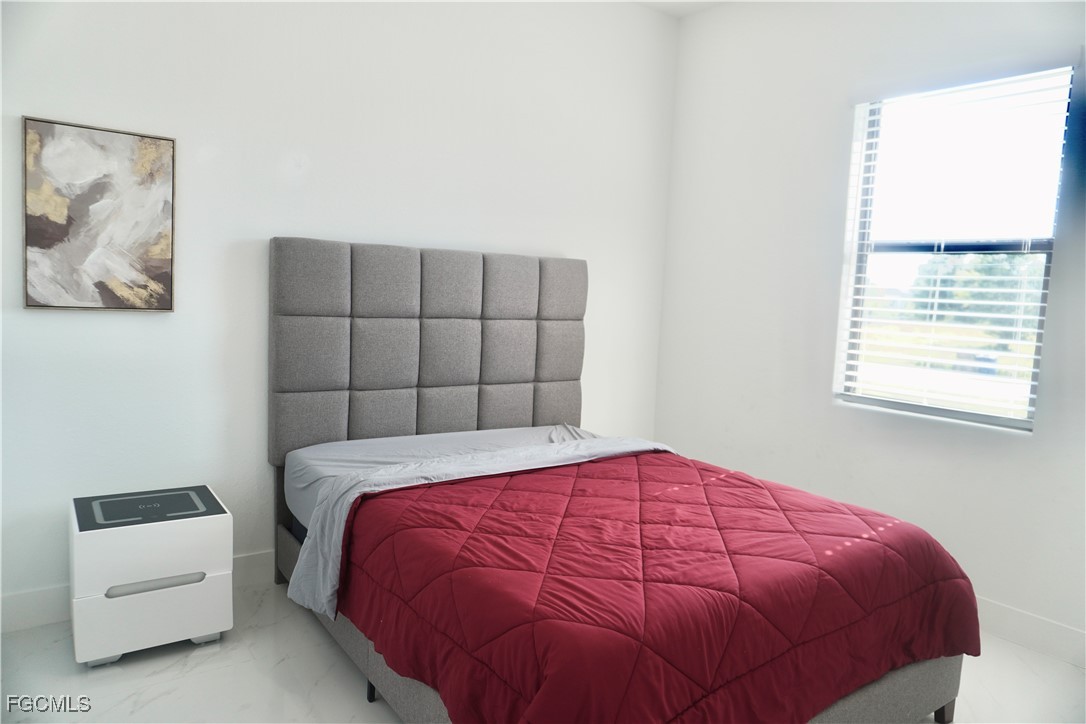 2608 25th Street West Lehigh Acres, FL 33971 - Photo 8 of 27 a bedroom with a bed and a window