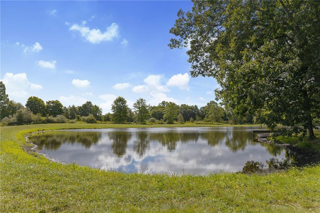 206 Lee Road Grove City, PA 16127 - Photo 25 of 44 a view of a lake with a yard and a fountain