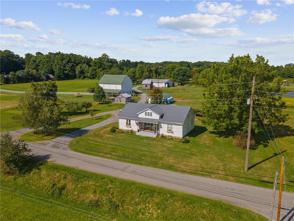206 Lee Road Grove City, PA 16127 - Photo 27 of 44 a view of a lake with lawn chairs and a big yard