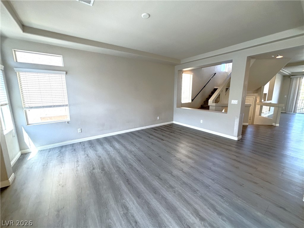 6425 Jackson Spring Road Las Vegas, NV 89118 - Photo 11 of 31 A spacious living area features wide plank flooring and an inviting view of the staircase.