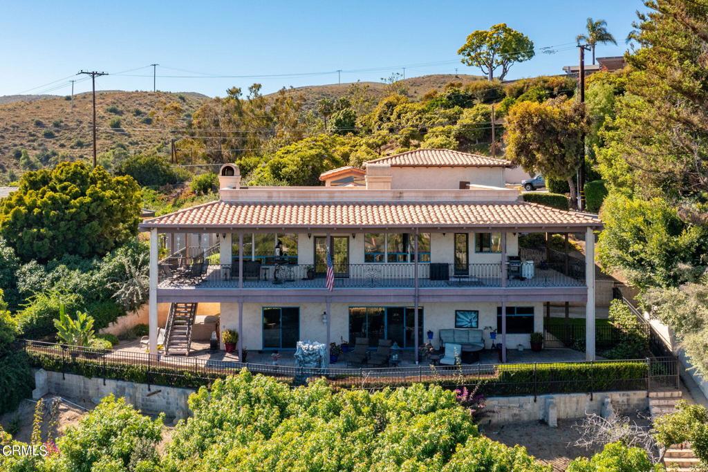 5240 Foothill Road Ventura, CA 93003 - Photo 1 of 1 a front view of a house with a yard swimming pool and outdoor seating