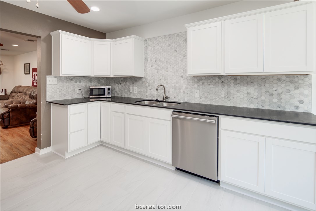 1204 East 28th Street Bryan, TX 77803 - Photo 11 of 22 a kitchen with white cabinets